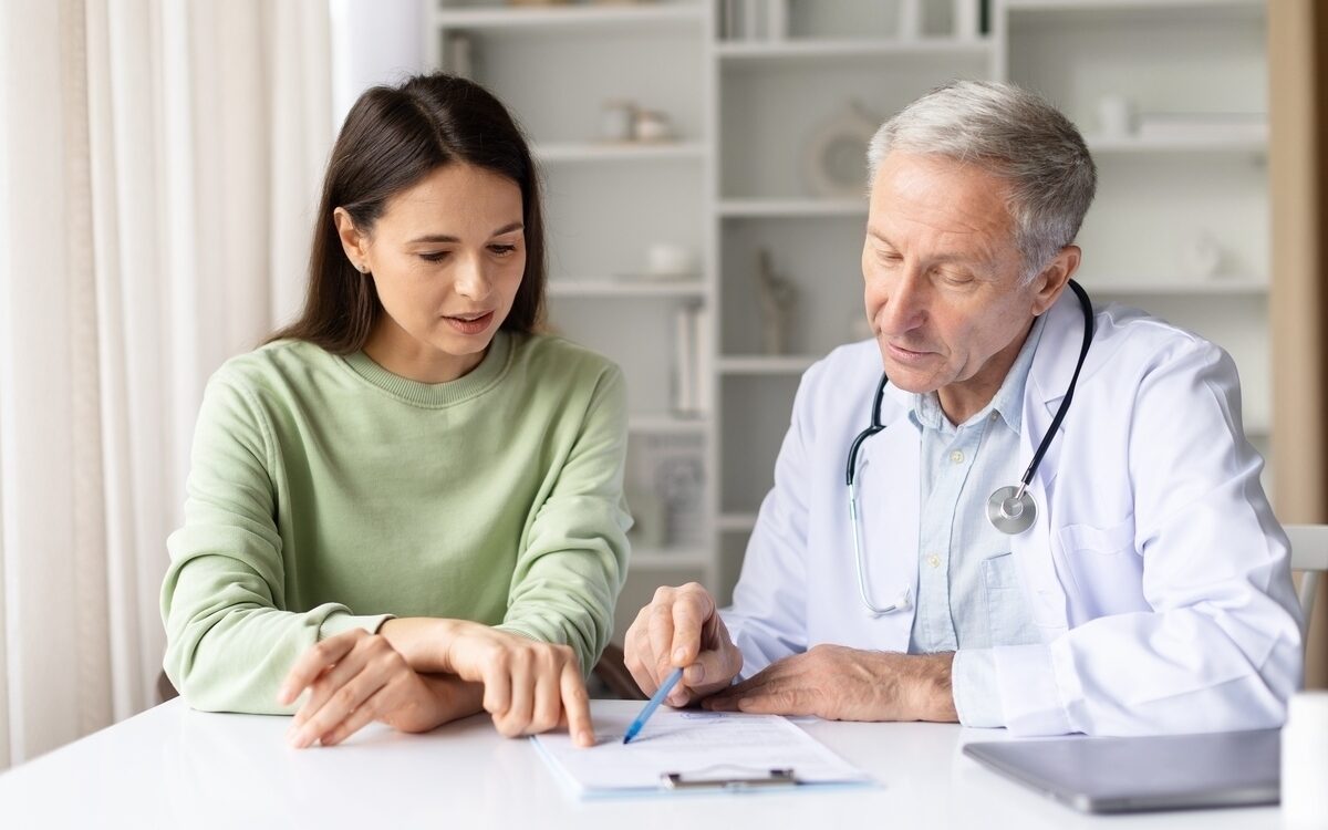 Patient and doctor reviewing a functional medicine treatment plan during a consultation