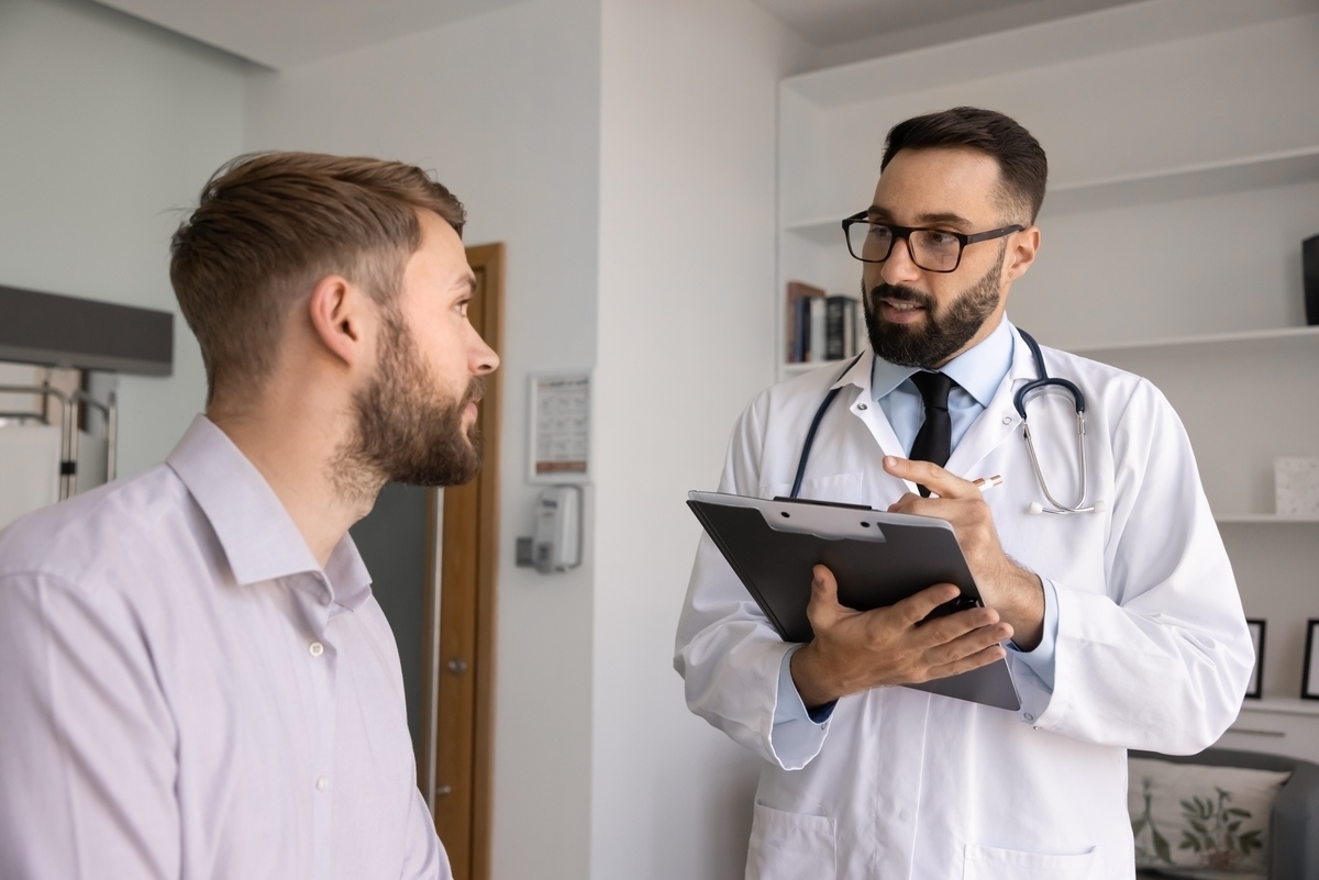 male physician reviewing results with a patient during a TRT in Southlake TX consultation at Apostol Integrative and Functional Medicine