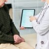 doctor reviewing blood test results on tablet during functional medicine testing consultation at Apostol Integrative and Functional Medicine