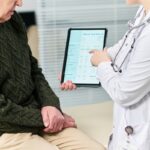 doctor reviewing blood test results on tablet during functional medicine testing consultation at Apostol Integrative and Functional Medicine