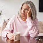 estrogen decline symptoms woman experiencing fatigue and mood changes at Apostol Integrative and Functional Medicine