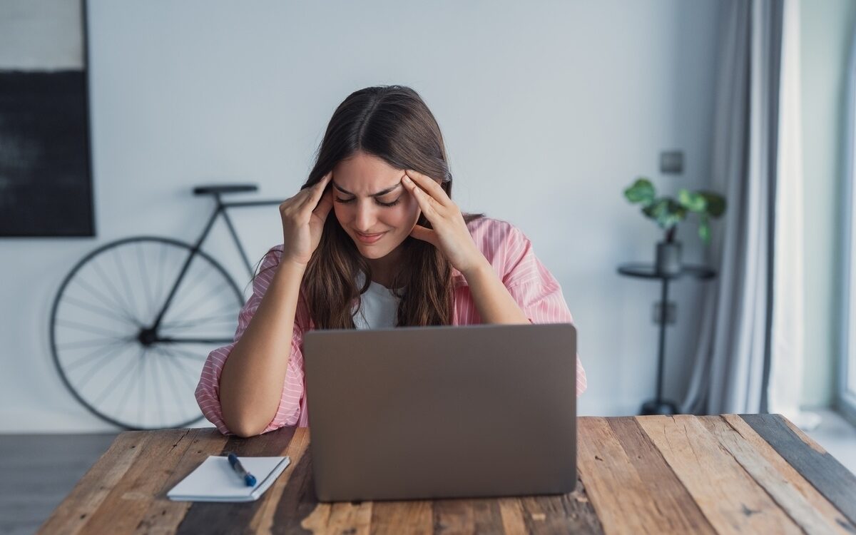 functional medicine for anxiety woman experiencing stress and tension at desk at Apostol Integrative and Functional Medicine