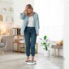functional medicine for weight loss woman frustrated standing on scale at Apostol Integrative and Functional Medicine