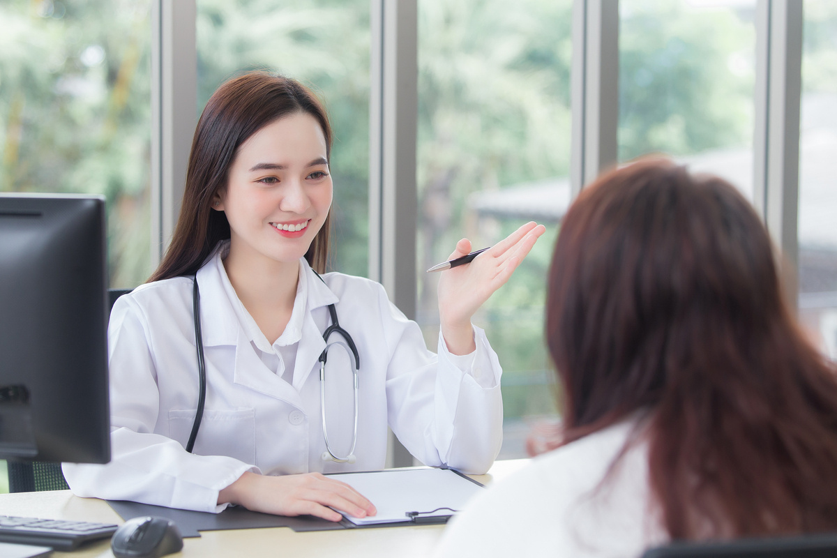 young female physician smiling and explaining findings during an HRT in Coppell TX consultation with a female patient